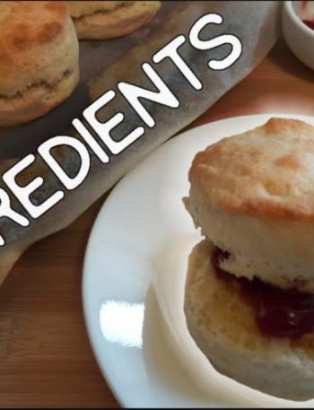 Scone on a side plate with butter and jam, in the background has the word 2 ingredients behind that some scones to the right some tubs with jam and butter.