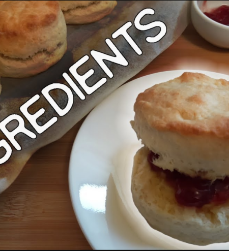 Scone on a side plate with butter and jam, in the background has the word 2 ingredients behind that some scones to the right some tubs with jam and butter.
