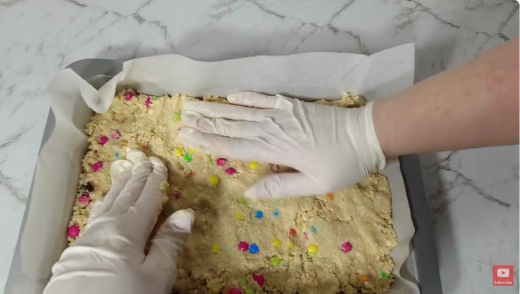 Pressing the 3-ingredient mixture in baking tin