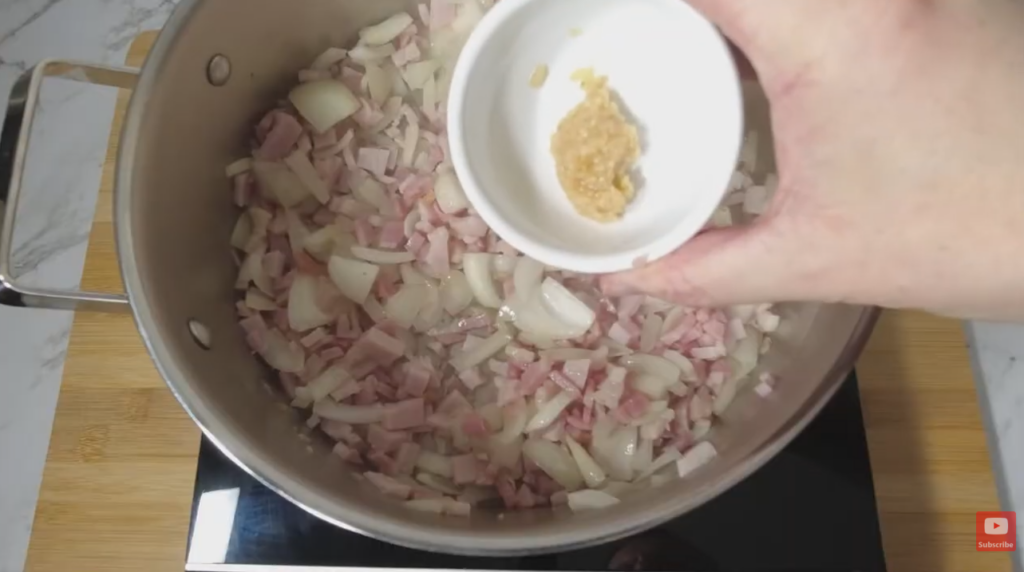Oil, onion, bacon, and garlic cooking.