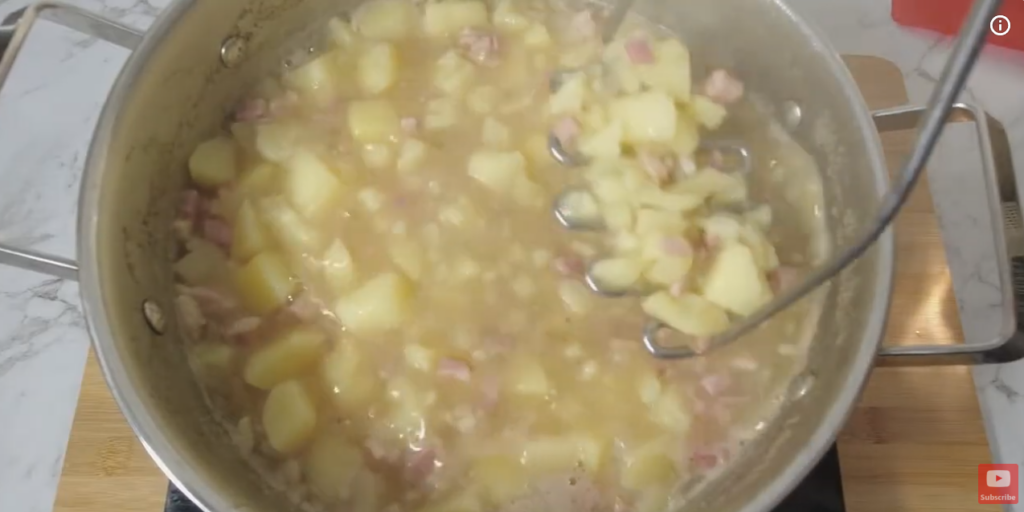 Pot with cooked Potato and Bacon Soup ready to be mixed.