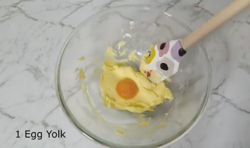 Creamed Butter and Icing Sugar in a glass bowl with 1 Egg Yolk