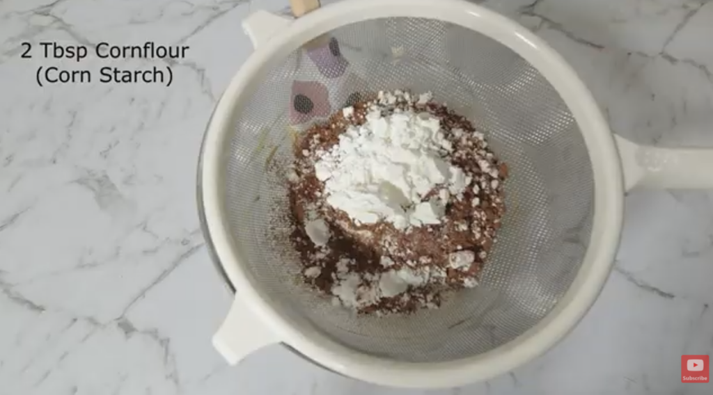 Dry ingredients in a sieve for coffee bean cookies