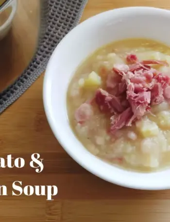 Bowl of Potato and Bacon soup with a soup spoon to the right and a pot of Potato and Bacon soup on the back left side.