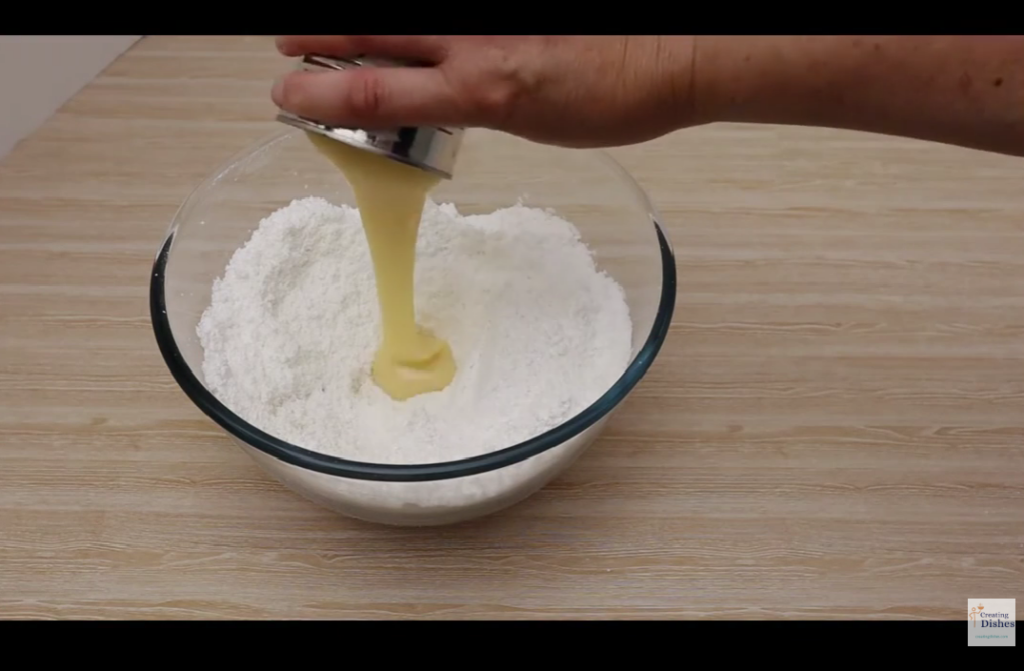Coconut Ice: adding condensed milk to the coconut and icing sugar.
