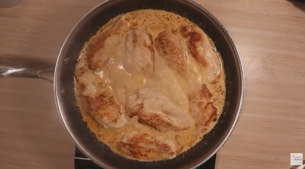 Marry ME Chicken cooked in a frying pan, ready to be served on a plate.