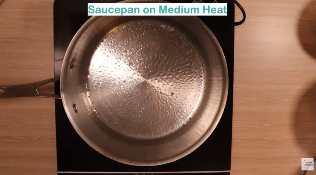 Saucepan heating with cooking oil sprayed in the pan