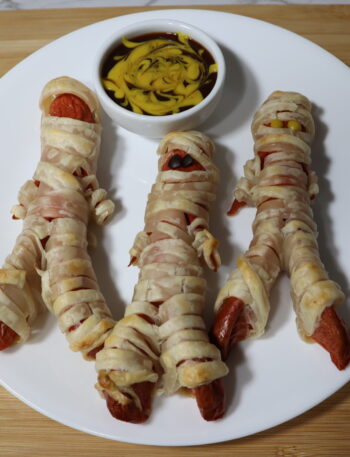 Halloween Mummy Dogs: Hot Dog sausages wrapped in puff pastry