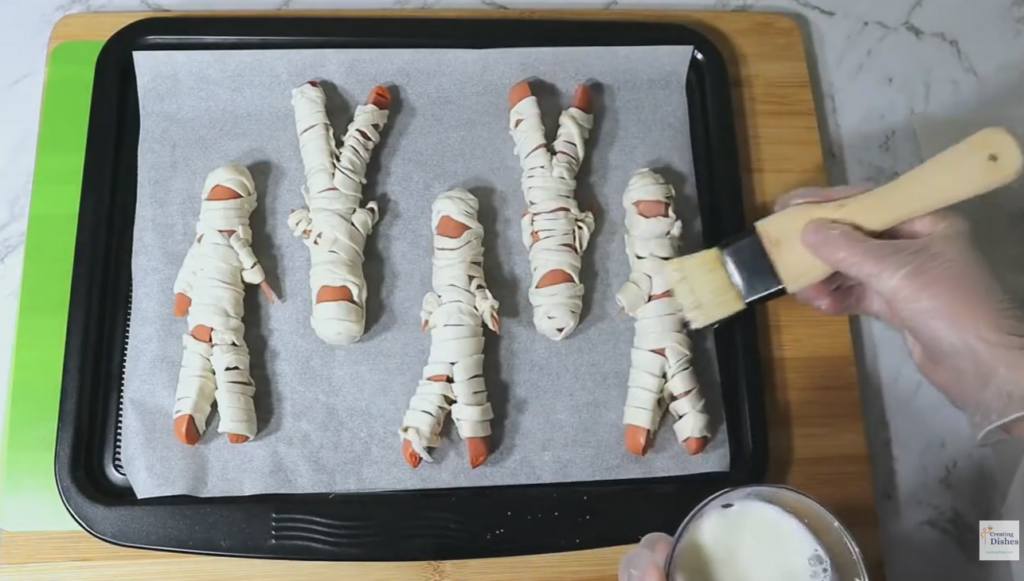 Halloween Mummy Dogs: Brush with milk.