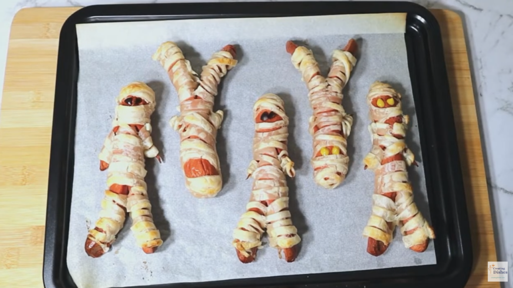 Halloween Mummy Dogs: Cooked and with eyes on.