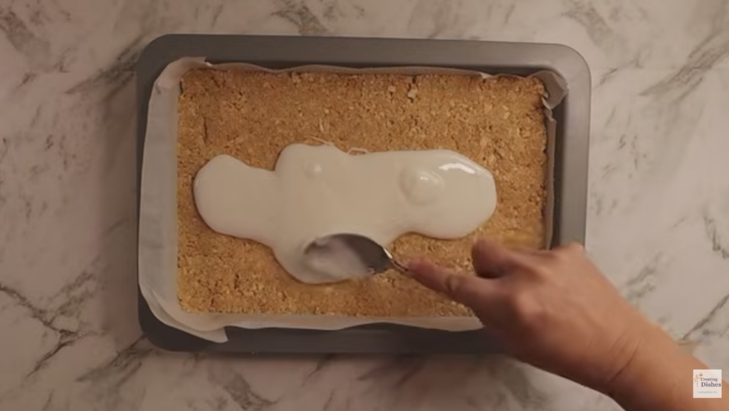 Spreading icing over the base.