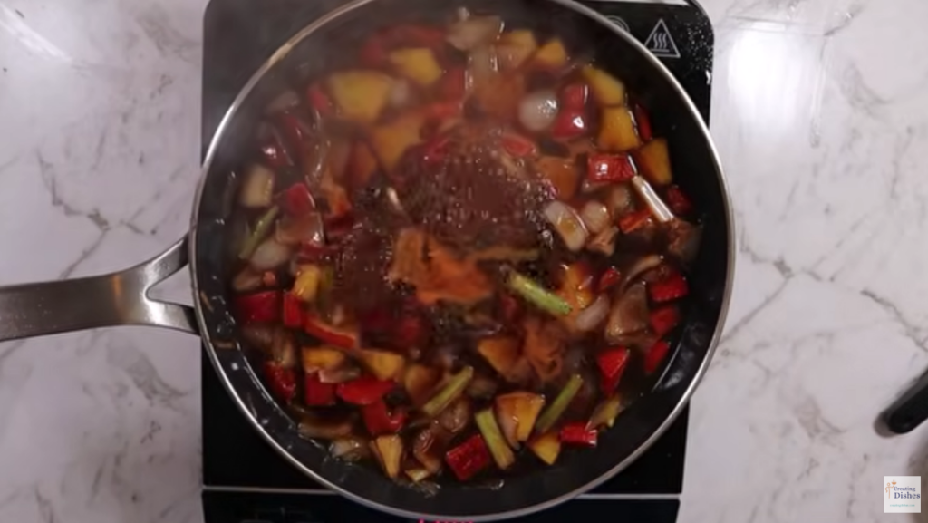 Sweet and sour sauce is being added to the vegetables